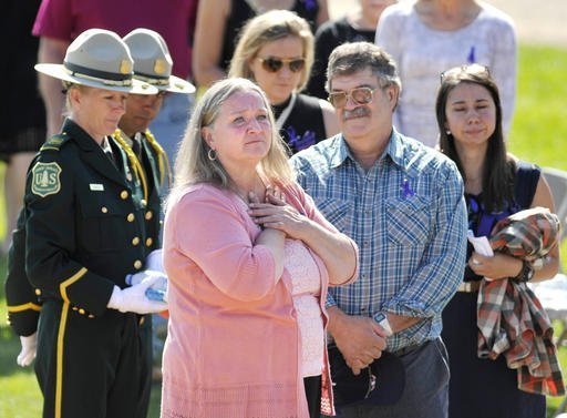 Fallen U.S. Forest Service firefighter Justin Beebe's parents Betsy, front, and Sheldon Beebe look out over the crowd before memorial service for Justin Beebe, Saturday, Aug. 20, 2016, in Missoula, Mont. Justin Beebe was killed Aug. 13, while battling a wildfire in Great Basin National Park in eastern Nevada. (Tommy Martino/The Missoulian via AP)
