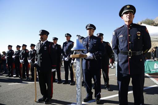 Firefighters from a variety of honor guards from around Arizona attend stand at attention during a dedication ceremony for the new Granite Mountain Hotshots Memorial State Park as a tribute to the 19 firefighters killed during a 2013 wildfire Tuesday, Nov. 29, 2016, in Yarnell, Ariz. Gov. Doug Ducey said the 3-mile trail and memorial would serve as a lasting tribute to the fallen firefighters' heroism.(AP Photo/Ross D. Franklin)
