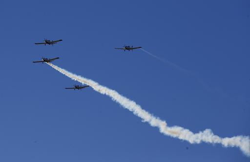 A missing man formation of fire fighting planes fly over a dedication ceremony for the new Granite Mountain Hotshots Memorial State Park as a tribute to the 19 firefighters killed during a 2013 wildfire Tuesday, Nov. 29, 2016, in Yarnell, Ariz. (AP Photo/Ross D. Franklin)