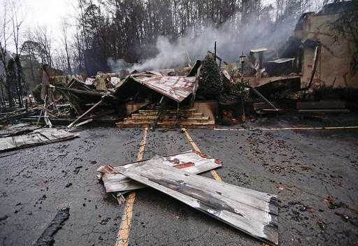 Smoke rises from the remains of the Alamo Steak House on Wednesday, Nov. 30, 2016, in Gatlinburg, Tenn., after a wildfire swept through the area Monday. Tornadoes that killed five people are adding to an onslaught of drought, flood and fire plaguing the South. The deadly overnight storms crashed into Alabama and Tennessee just as crews began to control wildfires around the resort town of Gatlinburg. (AP Photo/Mark Humphrey)