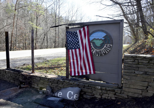 An American flag has been hung at the entrance to Gatlinburg , Tenn., Thursday, Dec. 1, 2016. A devastating wildfire destroyed numerous homes and buildings on Monday. (Michael Patrick/Knoxville News Sentinel via AP)